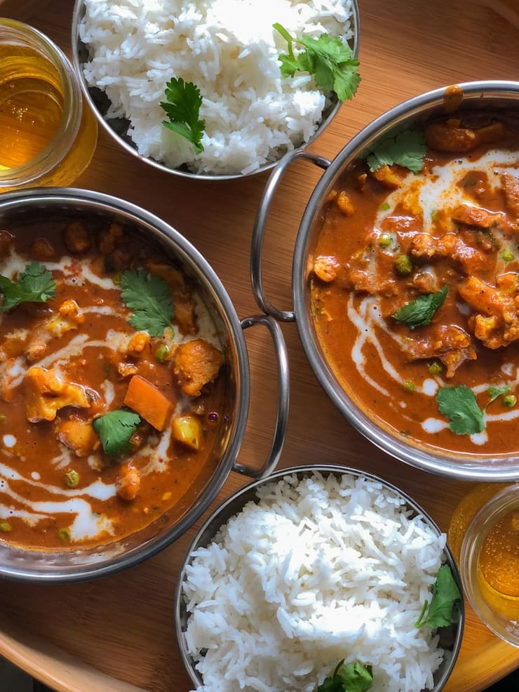 Dal and curry in steel bowls with rice