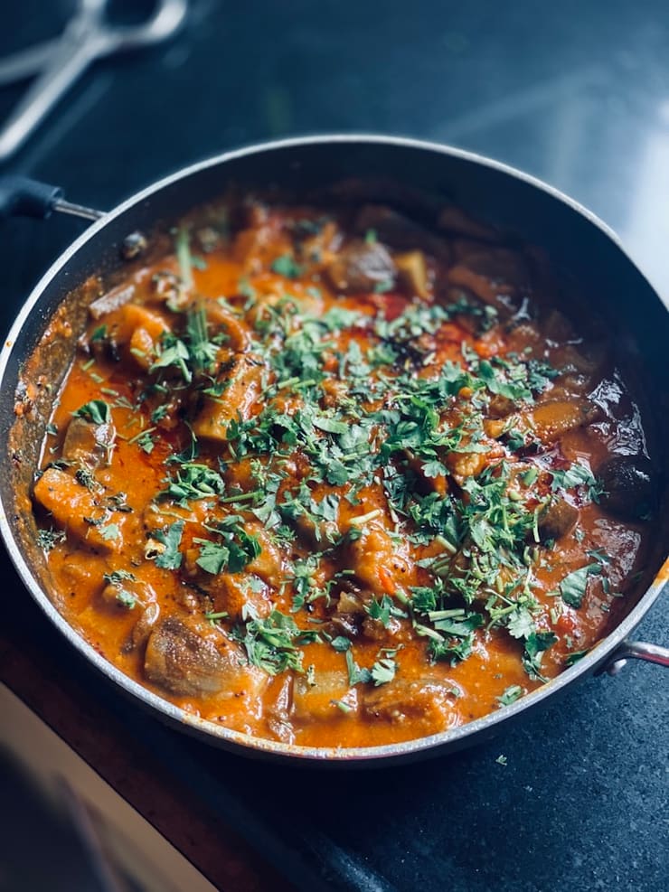 Goat curry cooking in a heavy karahi