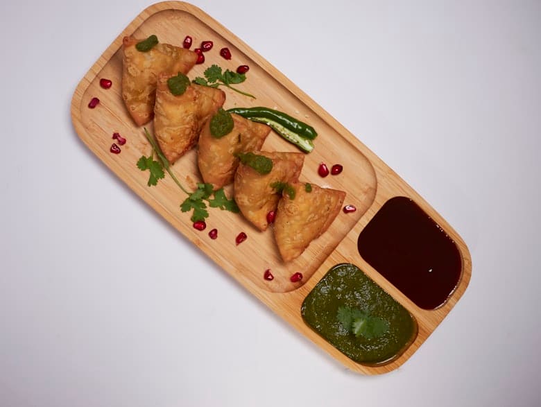 Samosas with tamarind and mint chutney