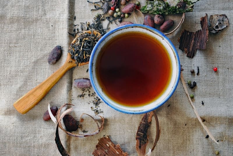 Masala chai in a bowl with whole spices